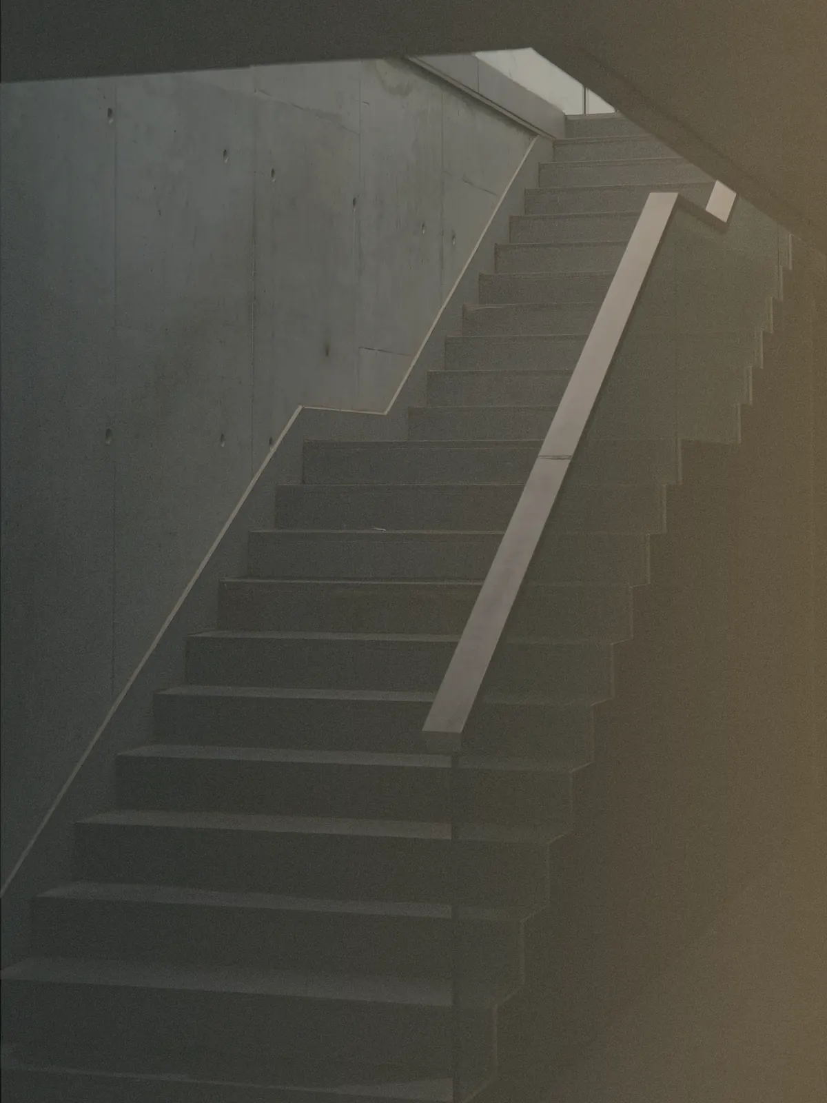 A concrete stairway rising toward light, suggesting growth and purposeful movement